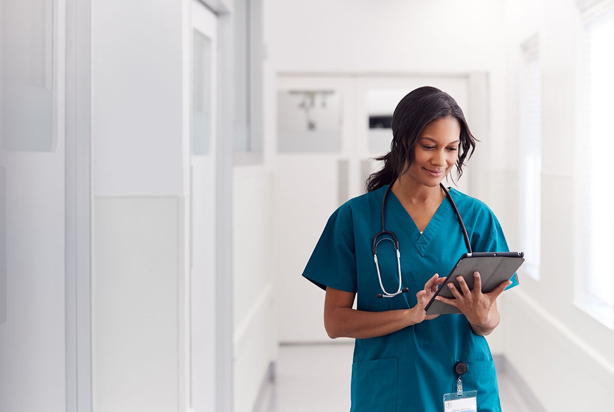 Doctor using a digital tablet in a hospital corridor