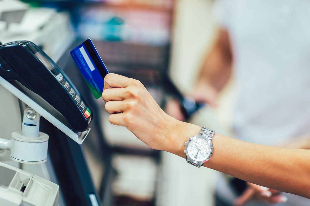 Customer paying with a contactless card at a retail checkout