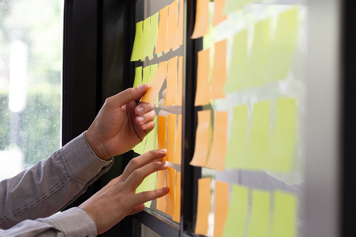 IT professional tracking tasks on a kanban board